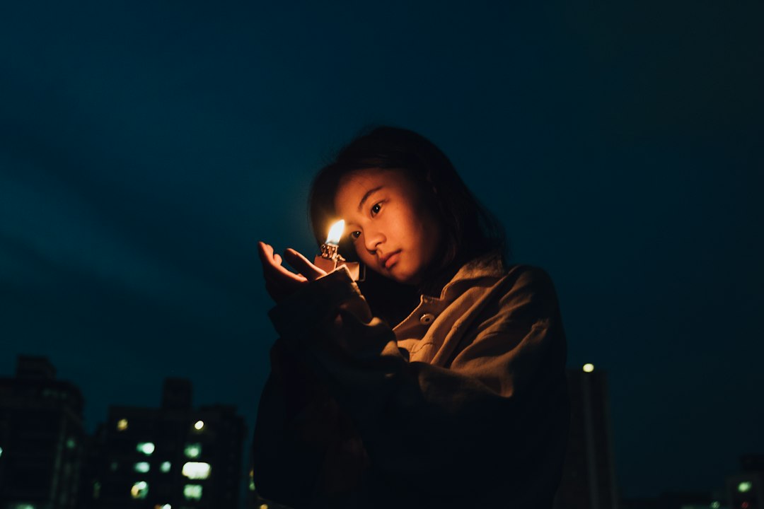 woman worried holding smartphone night