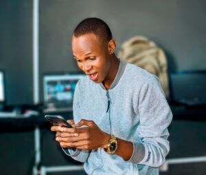 man texting smiling subtle