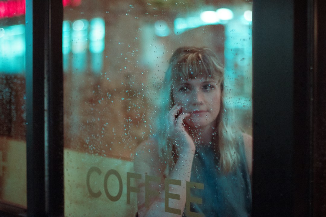 woman thinking coffee shop window