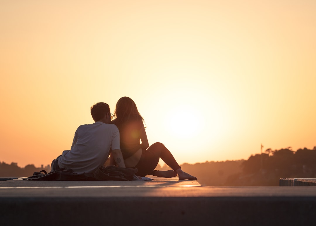 happy couple smiling outdoors sunset