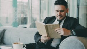 calm thoughtful man reading in cafe