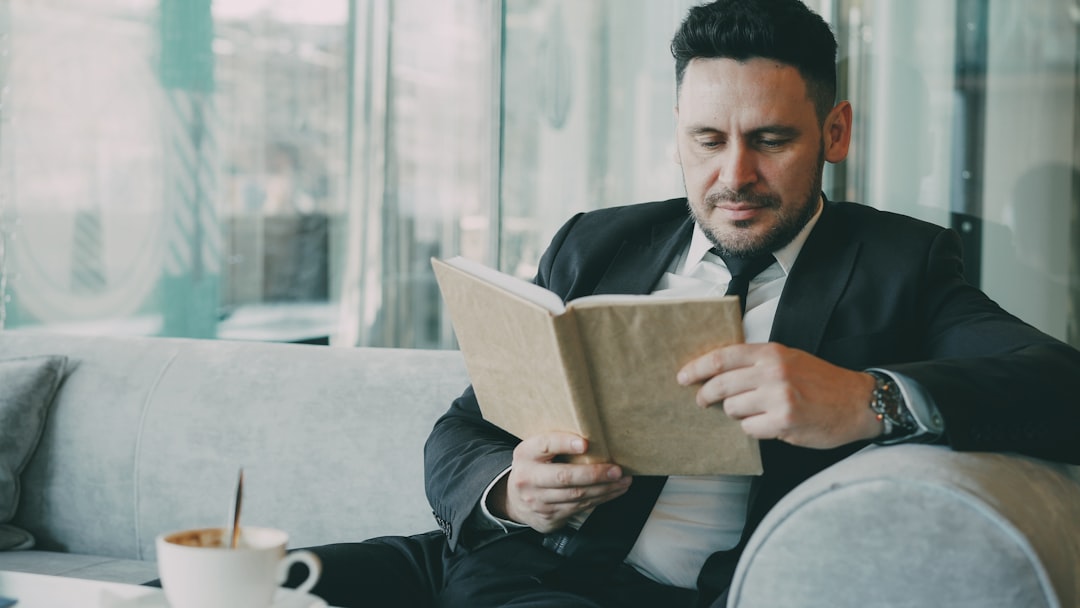 calm thoughtful man reading in cafe