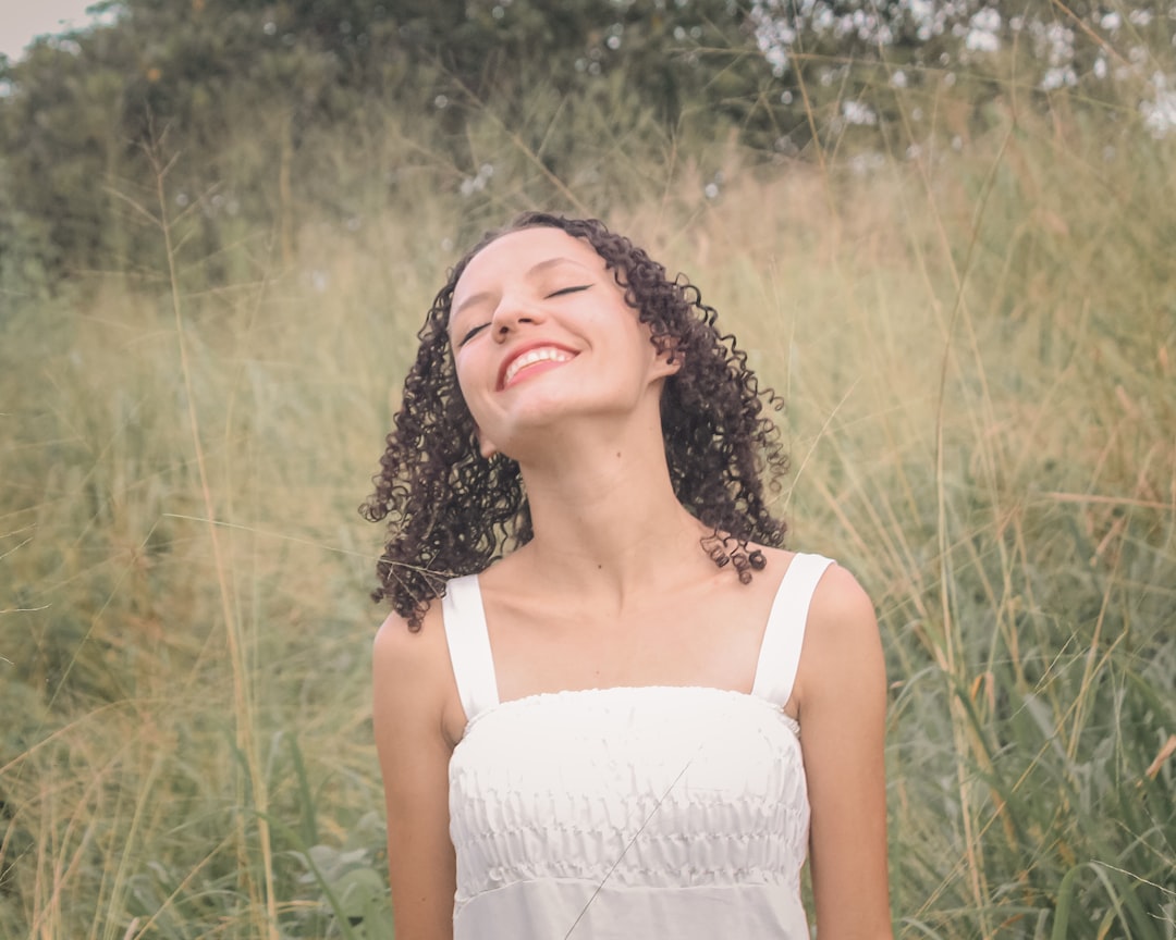 cheerful young woman laughing outdoors