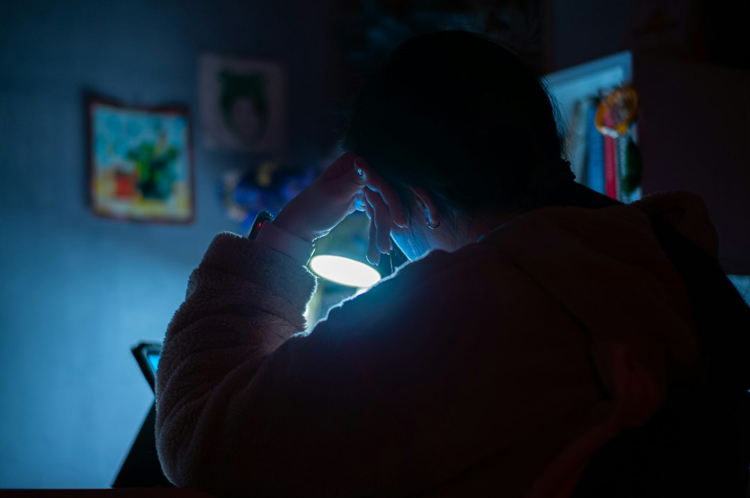 person looking worried at phone night