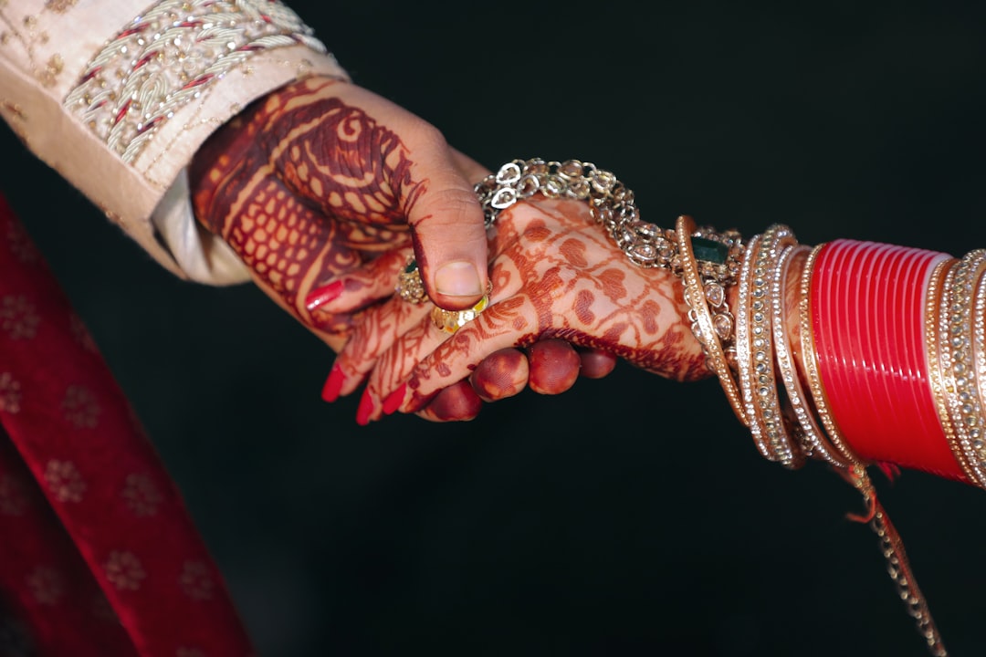 couple holding hands wedding rings