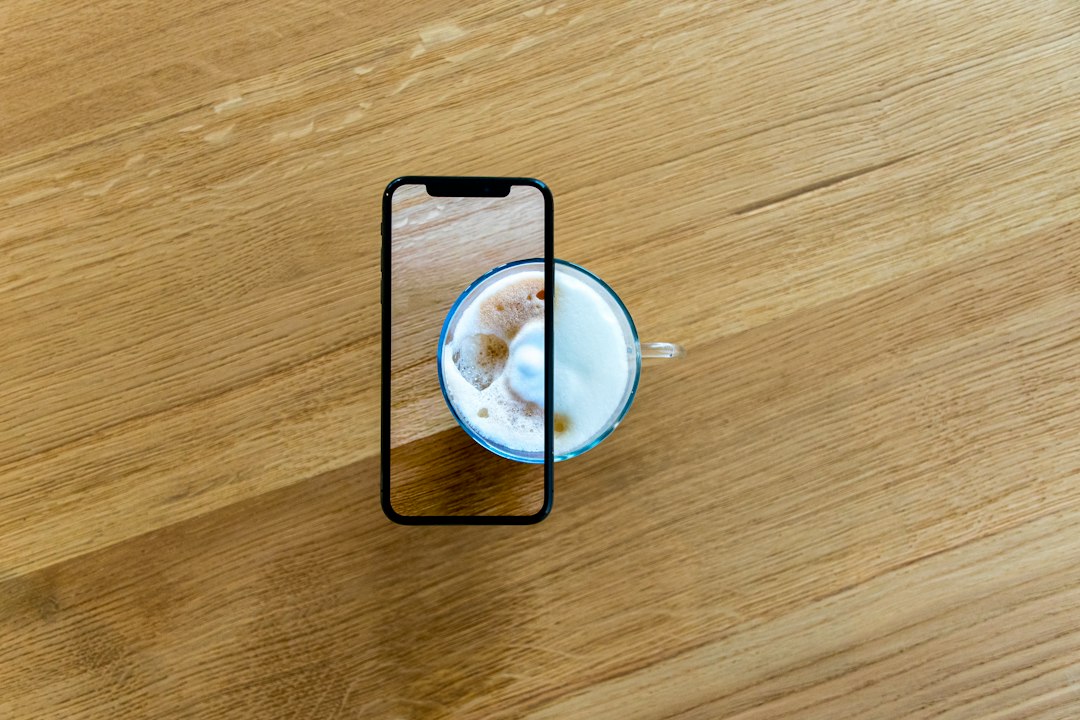 smartphone with profile screen on cafe table