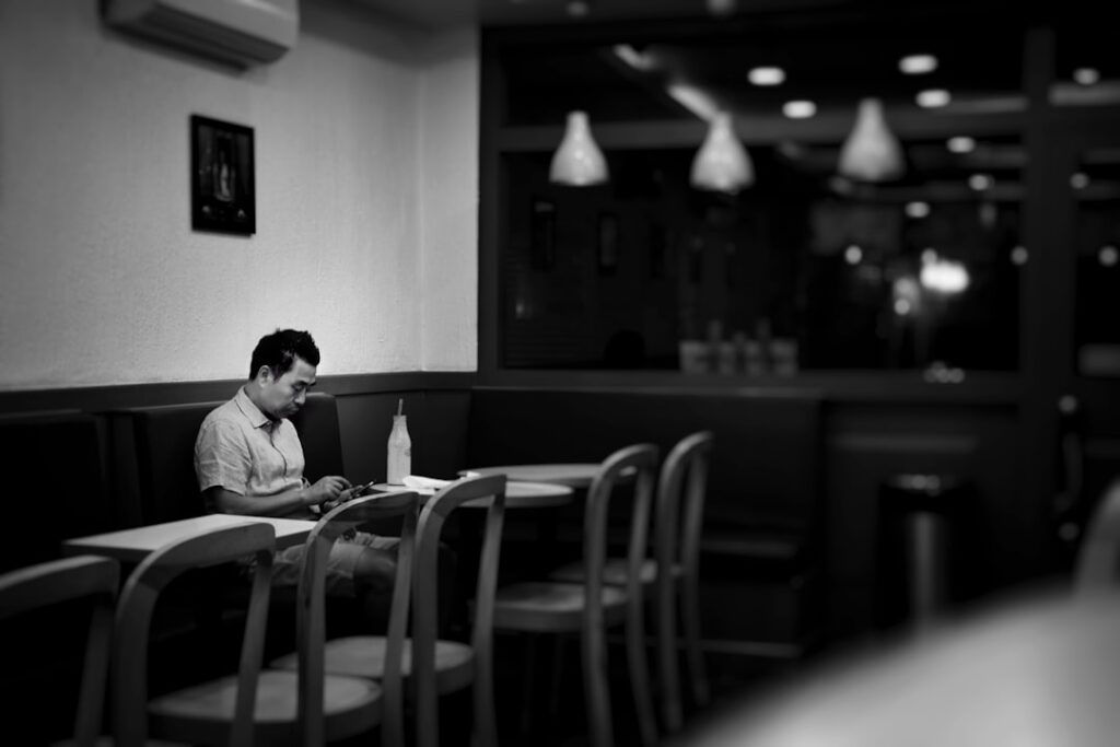man sitting alone quiet cafe thinking
