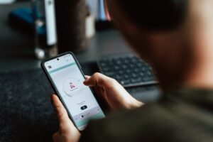 man using dating app smartphone at night