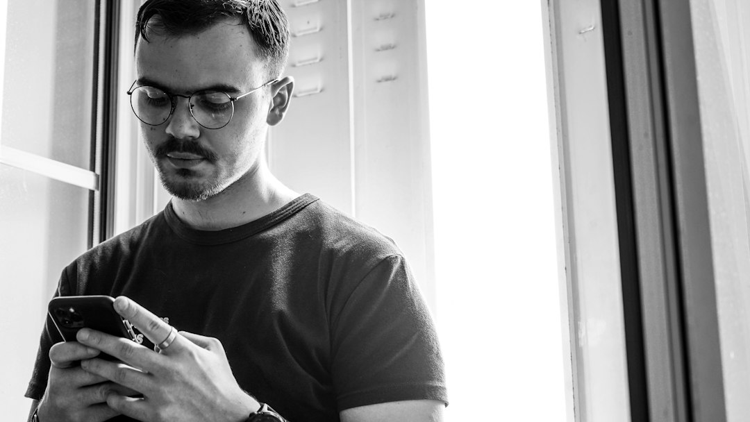 man looking at smartphone quietly