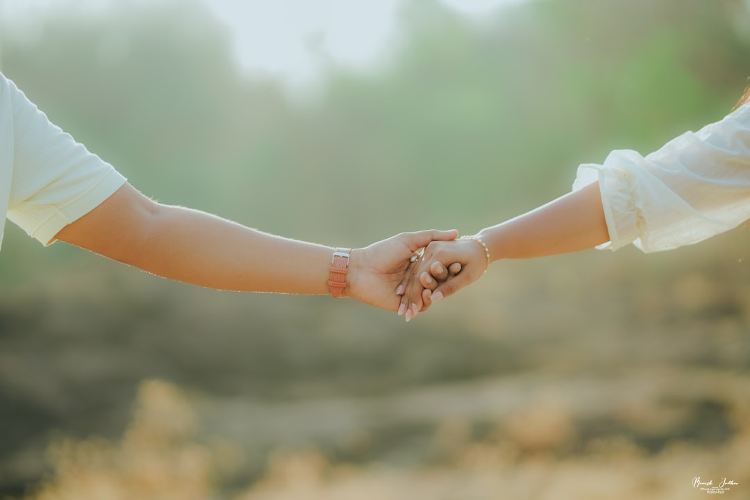 mother and child holding hands outdoors sunny day