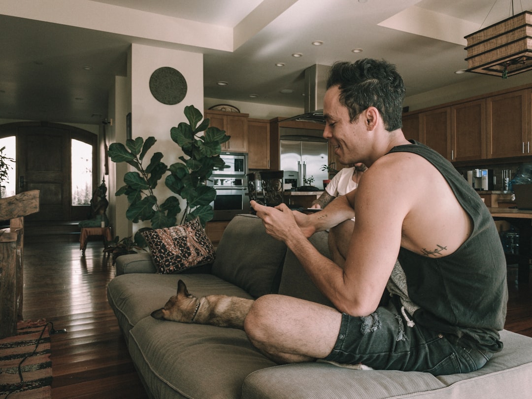 person relaxing at home with phone in evening