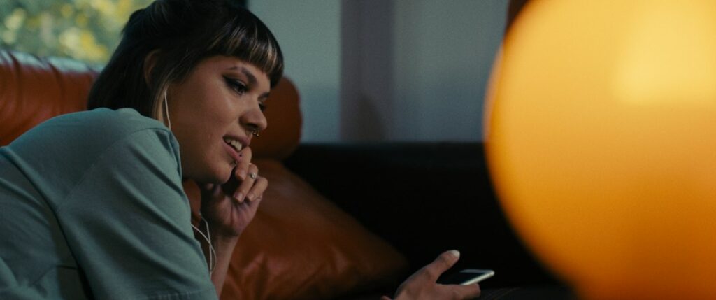 woman looking at phone late night anxious