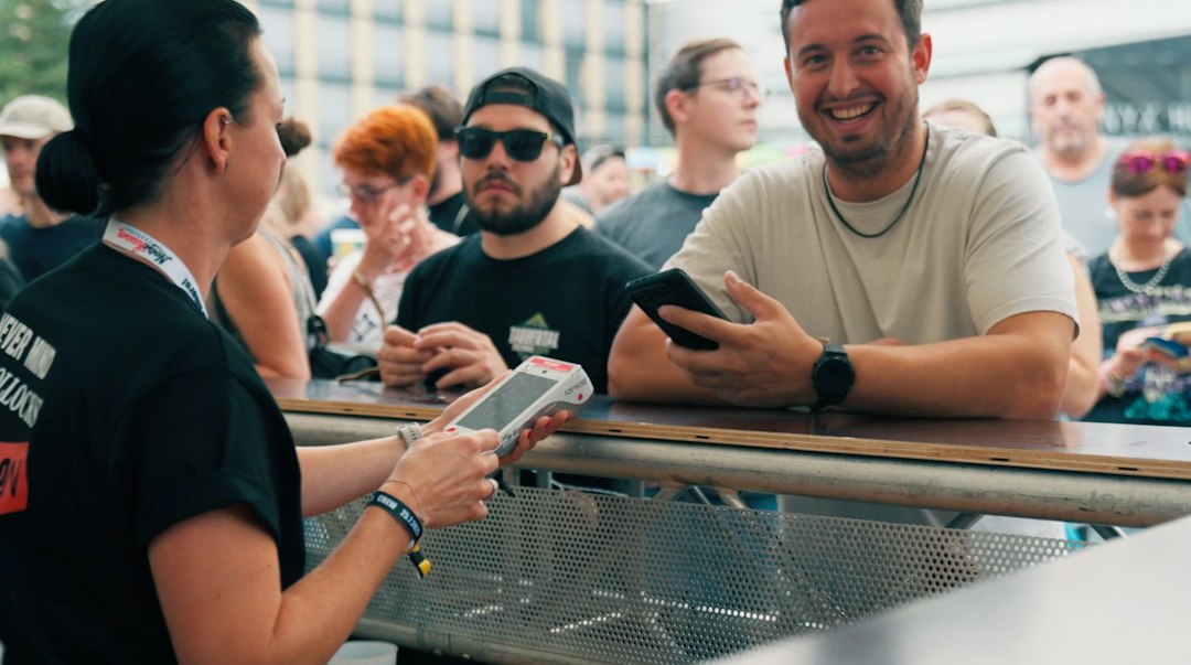 two people exchanging phone contacts at event