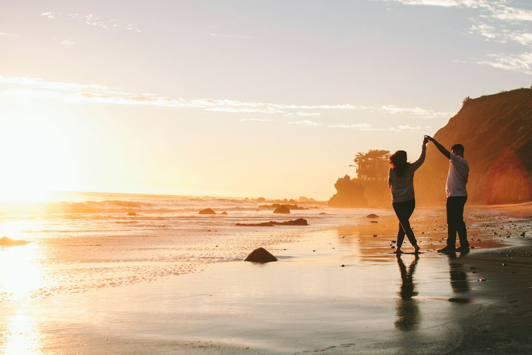 happy couple walking outdoors sunset
