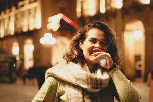 woman looking at phone late at night thinking