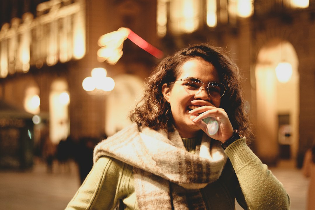 woman looking at phone late at night thinking