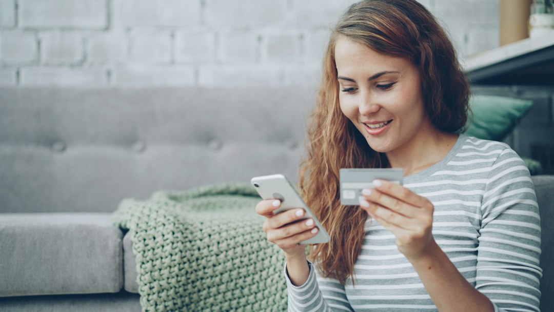 woman reading text message smiling