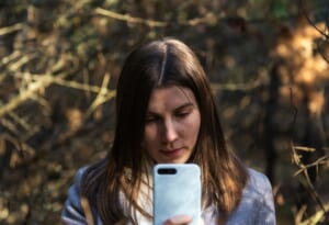 woman smartphone identity verification worried