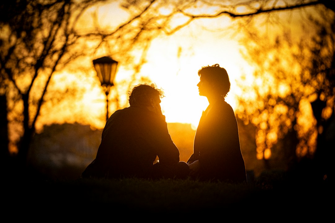 couple holding hands sunset park