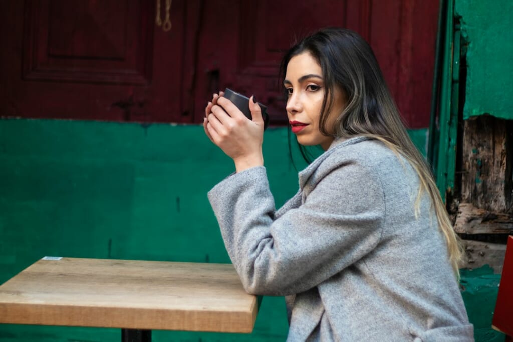 woman looking at smartphone worried cafe